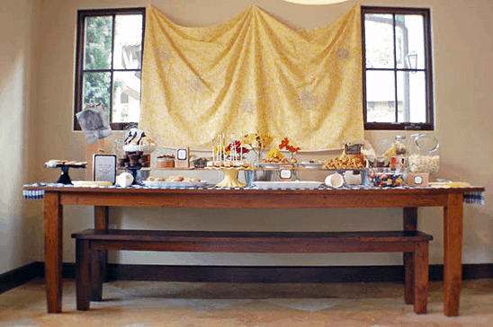 A wooden table decorated for a baby shower. 