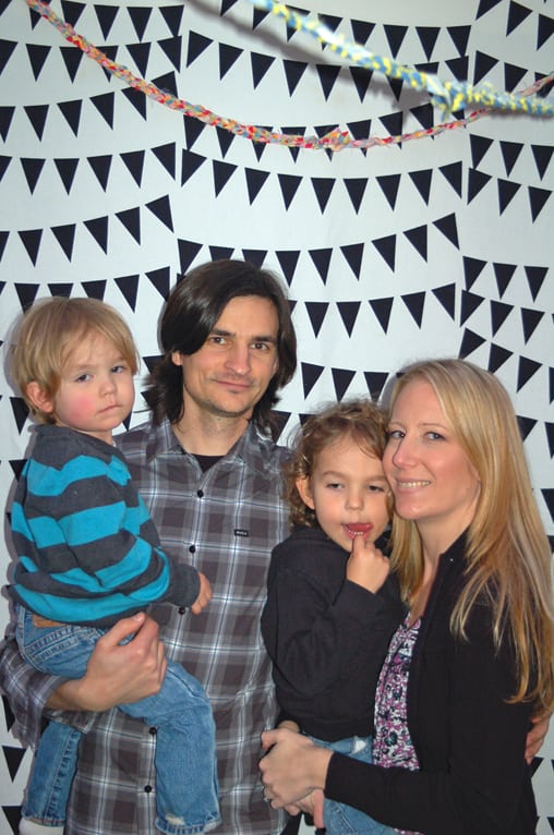 A family in front of a photo backdrop.