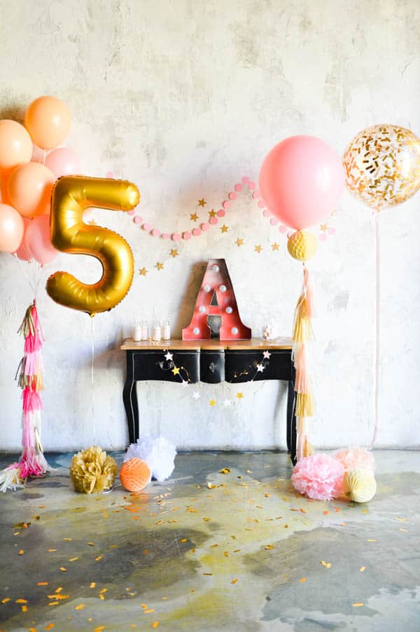 A small table with big balloons around it for a party.