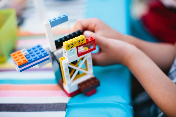 Kid building with Legos at a birthday party.