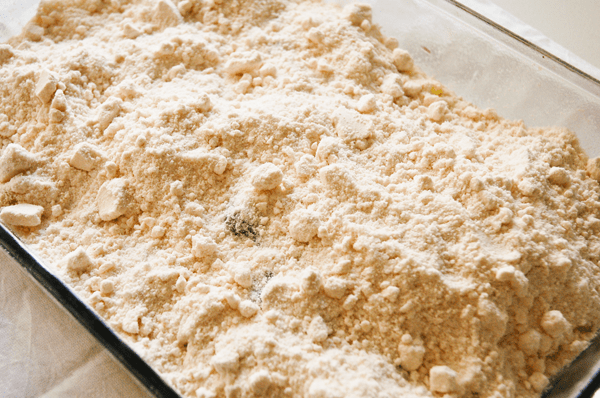 A glass baking dish with dry yellow cake mix.