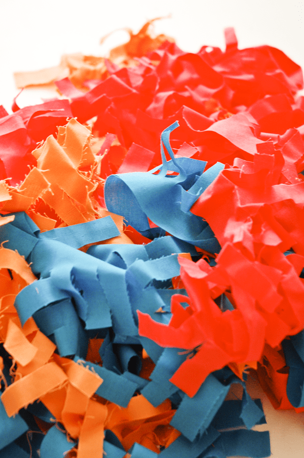 A pile of colorful fabric fringe on a table. 