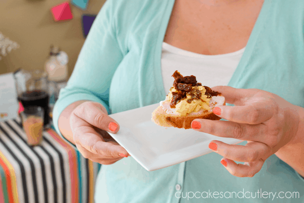 Woman holding an egg on toast.