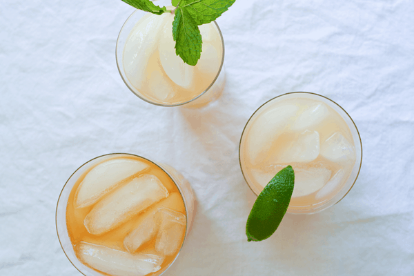 Overhead shot of cocktails on a table made with grapefruit juice. 