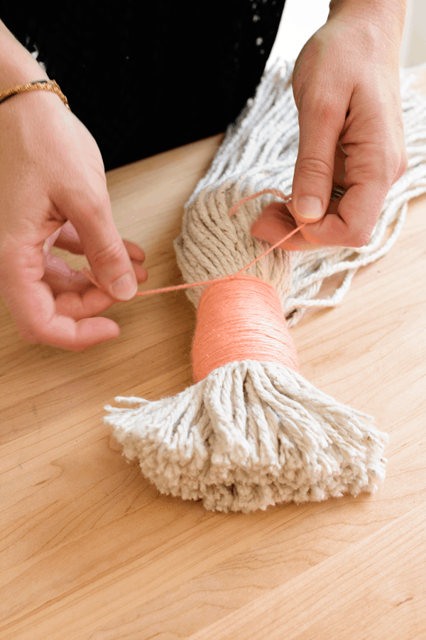 Use a little embroidery thread to turn a mop head in to a large tassel decoration. 