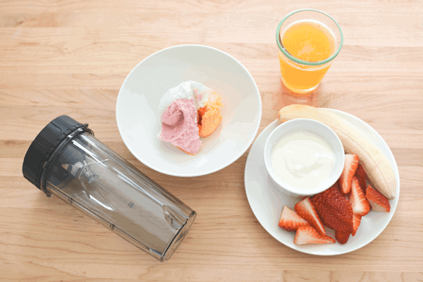 Passion fruit smoothie with rainbow sherbet, stawberries and banana. // www.cupcakesandcutlery.com