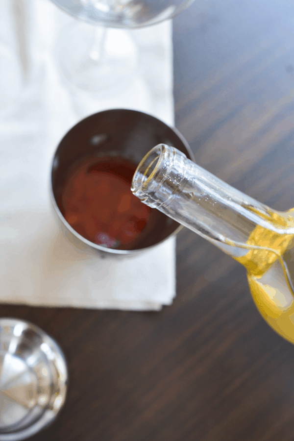 Pouring wine into a cocktail shaker. 