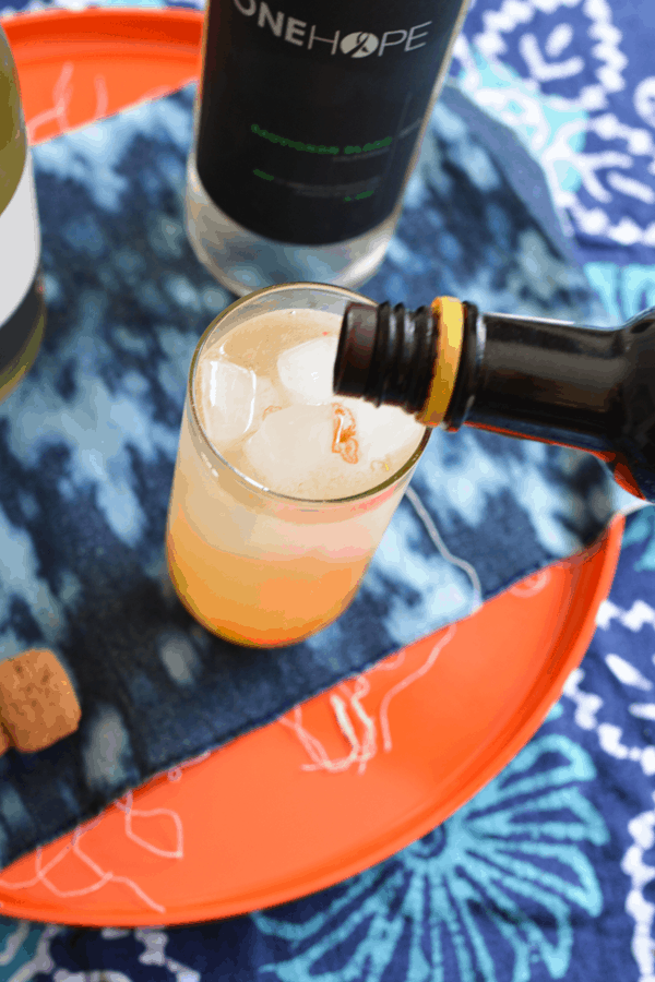 Topping off a wine cocktail with sparkling wine. 