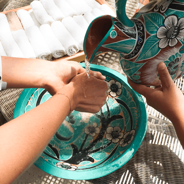 Hand washing ceremony upon arrival at Villa del Palmar Loreto. 