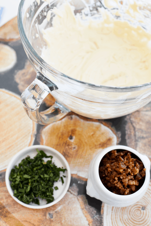 A bowl of food on a table, with Bacon and Cream cheese