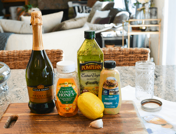 Ingredients for a champagne vinaigrette dressing on a cutting board.