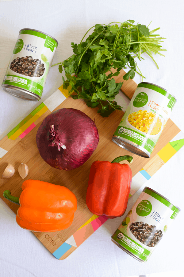 Ingredients to make a Black Bean Salad recipe on a cutting board. 