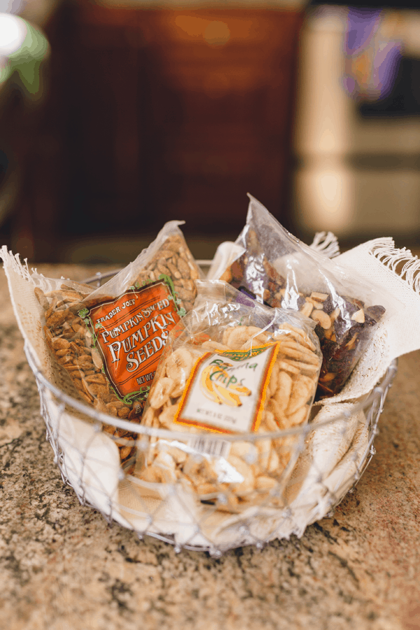 Bowl holding a variety of bagged snacks.