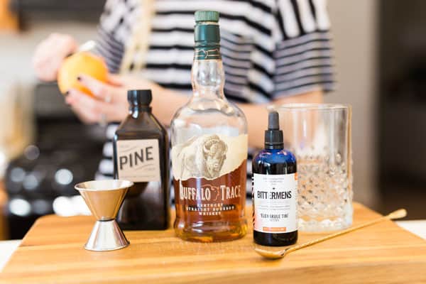 Ingredients to make a Pine Old Fashioned on a counter. 