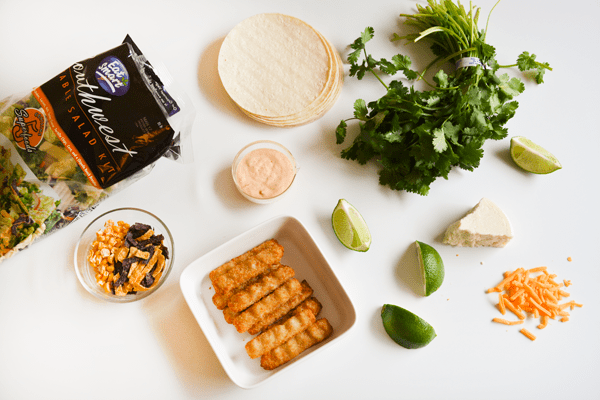 Ingredients on a table to assemble fish stick tacos for dinner.