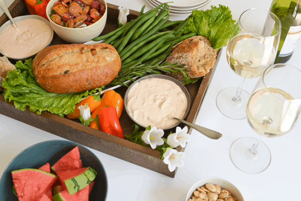 A tray full of veggies and dips for a party. 