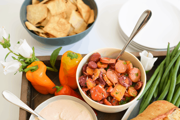 Close up of a bowl of carrot salad on a party food table. 