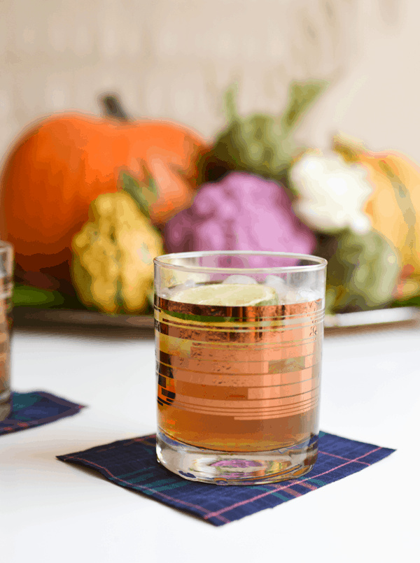 Pumpkin Moscow Mule Recipe with Rum on a table with a fall centerpiece behind it. 