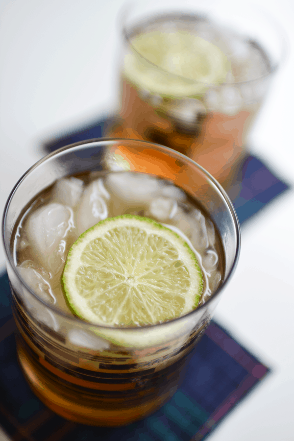 Close up of a lime garnish in the top of a Pumpkin Moscow Mule in a cocktail glass.