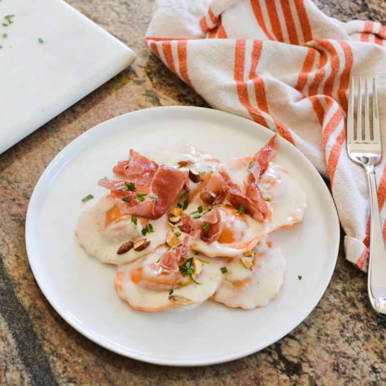 Butternut Squash Ravioli with Alfredo Sauce, Prosciutto and Almonds