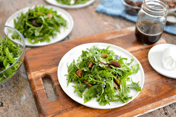 Arugula salad with pecans and beets on a plate. 