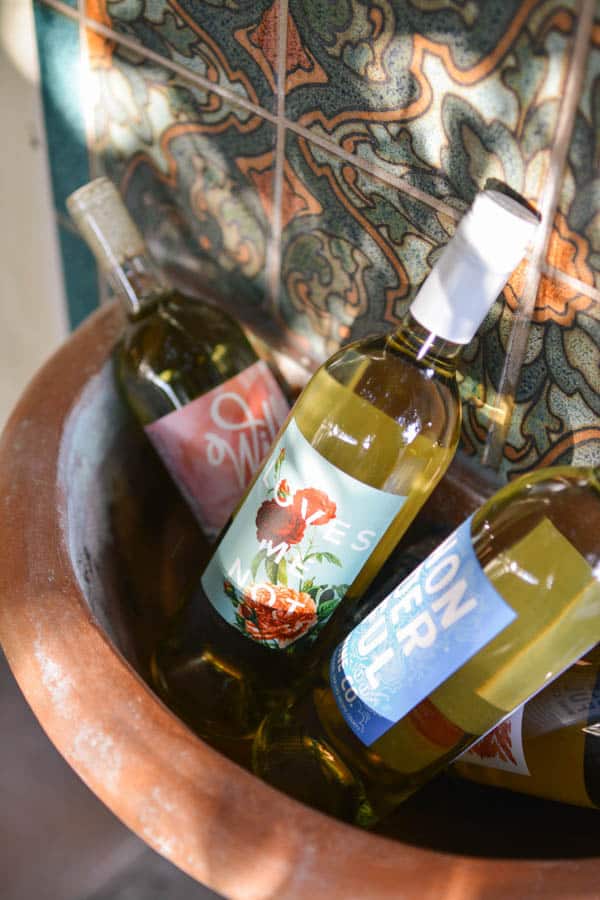 Wine bottles in a terracotta fountain pool.