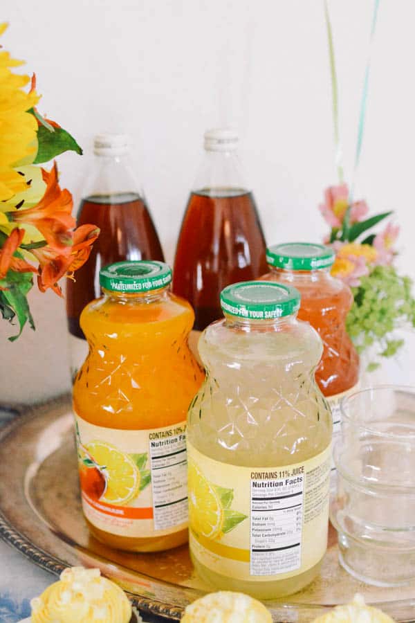 Flavored lemonade drink station, set up on a table, for graduation party.