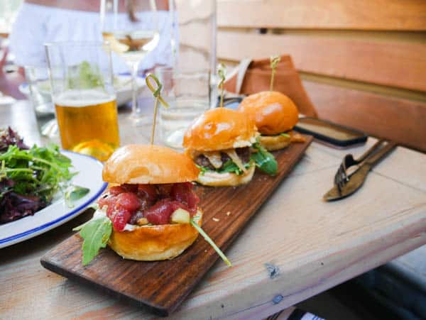 Close up of 3 sliders on a restaurant table for a moms night out.