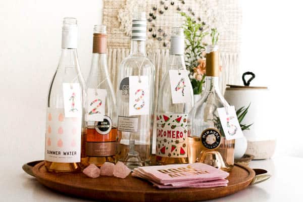 5 Bottles of Rose Wine to Try for a Wine Tasting sitting on a table with numbered labels. 