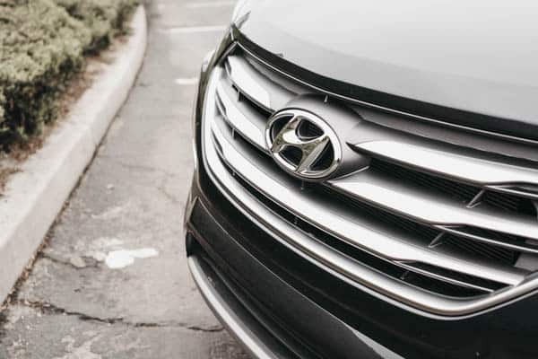 Grill of a 2018 Hyundai Santa Fe plus rap playlist.