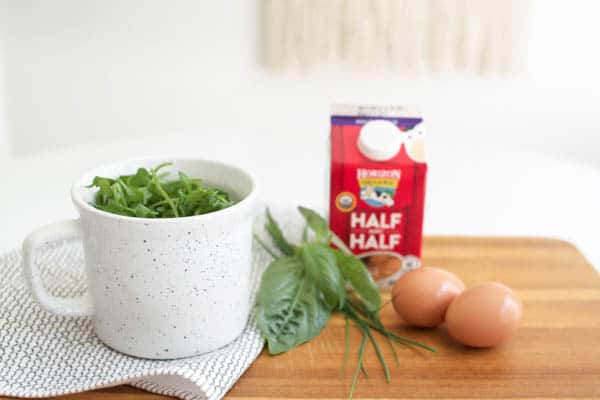 Baked eggs topped with arugula for a healthy breakfast.