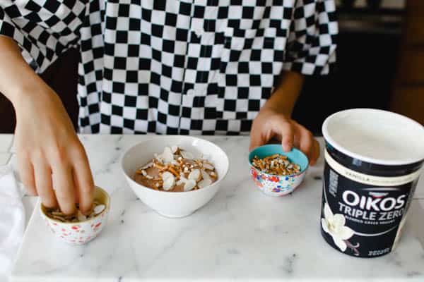 This chocolate and yogurt fruit dip recipe is a great after school snack idea that can be topped with almonds and pretzels.