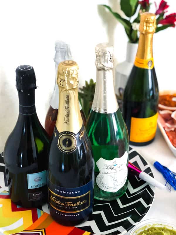 Close up of bottles of sparkling wine on a tray. 