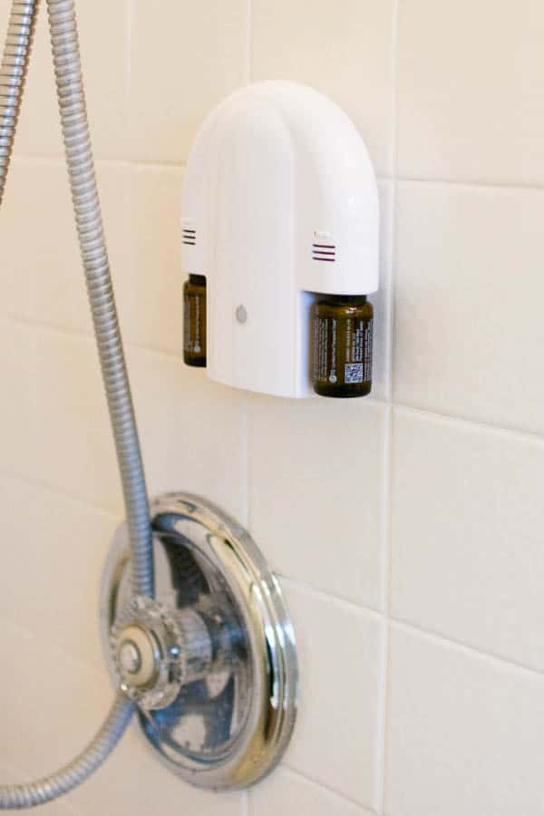 An aromatherapy oil diffuser on a shower wall. 