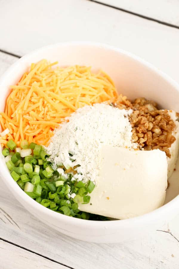 Ingredients for a chicken ranch cheese ball in a white bowl.