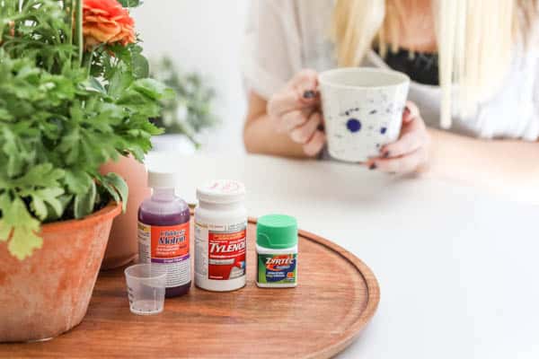 A tray on a table with bottles of over the counter medicine.