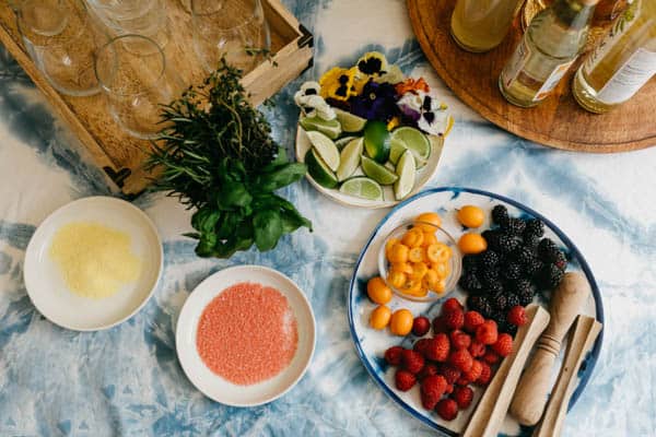 Fruit and herbs on plates for garnishing mocktails for mother's day.