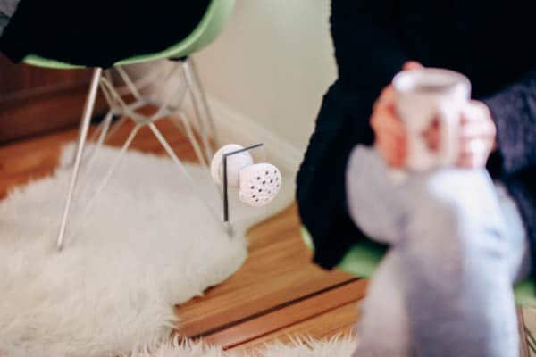 Close up of an essential oil diffuser plugged into a wall outlet. 