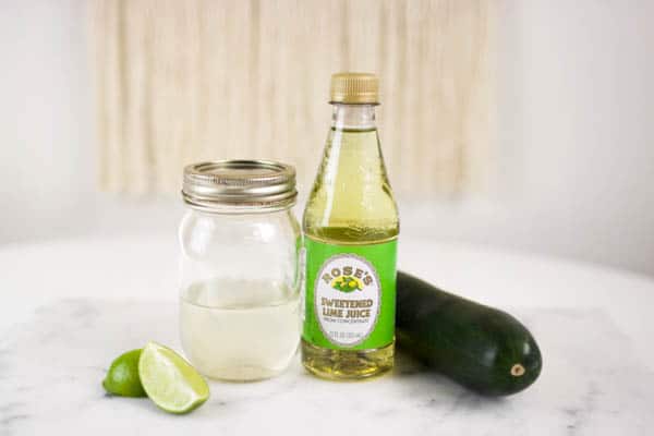 Ingredients for cucumber vodka gimlet on a table. 