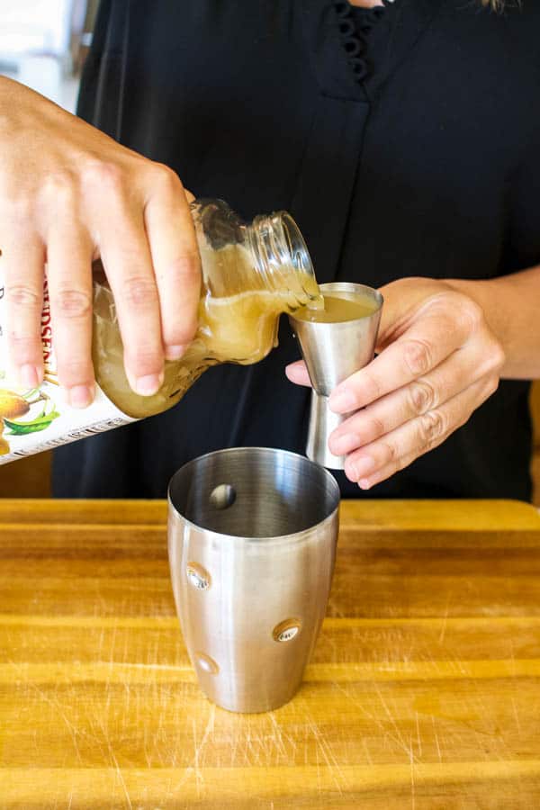 Pouring pear nectar for a pear martini.