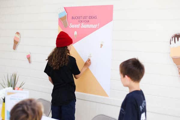 Boy sticking something on a poster at a party