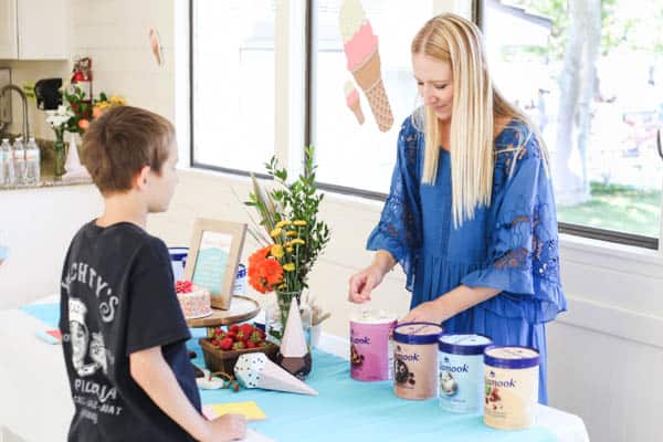 woman giving boy a sample of ice cream