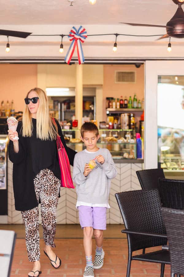 mom and son walking out of an ice cream shop