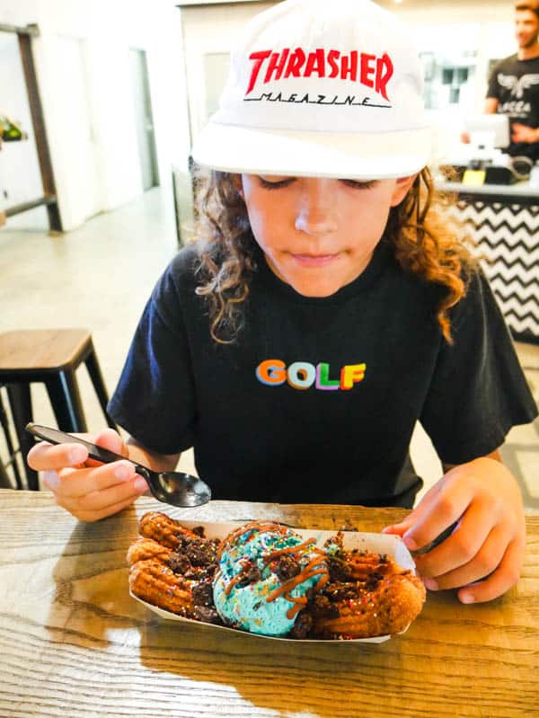 kid eating Locca Churro Bacadillo at Union Market in Mission Viejo