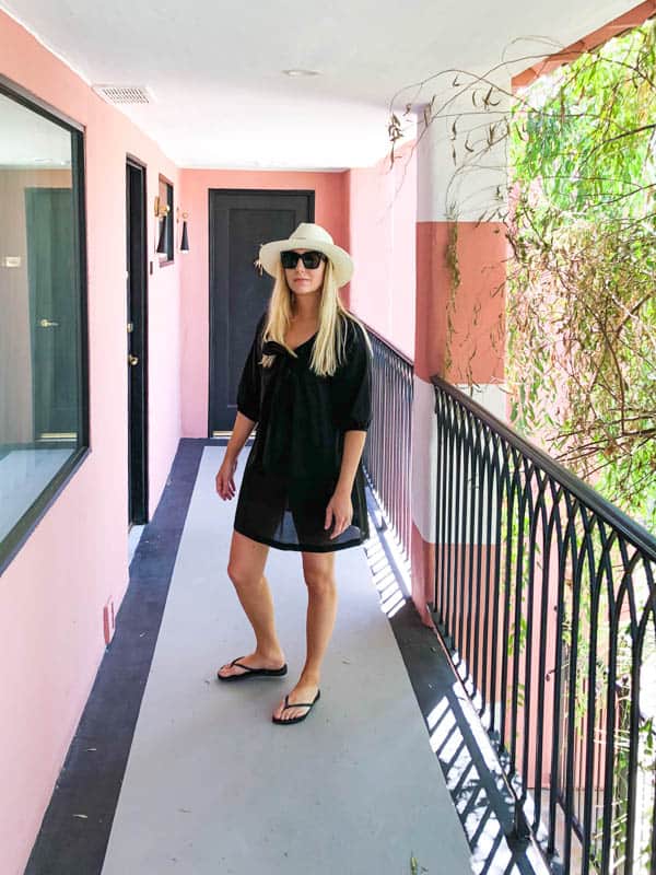 Woman in pink hallway of the sands hotel in palm springs.