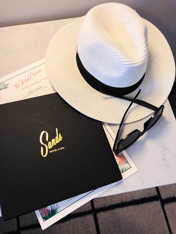 Menu and hat on a table at The Sands Hotel Indian Wells.