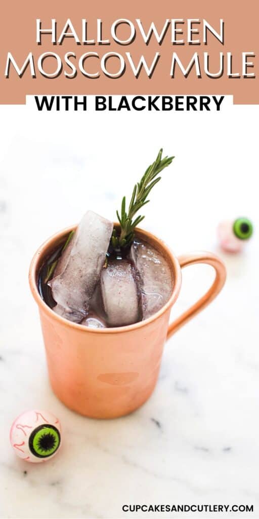 Overhead view of a Blackberry Moscow Mule with a rosemary sprig and fake eyeballs on the table around it.