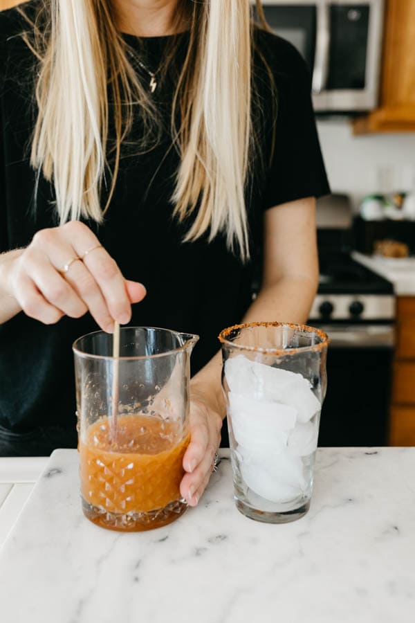 Woman making beer and pumpkin michelada.