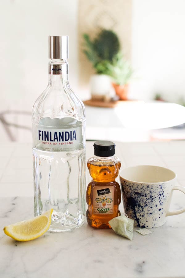 Ingredients for a hot green tea toddy recipe on a counter. 