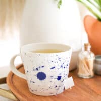 green tea vodka in a mug on a table.